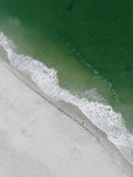 Aerial fine art photograph of emerald Atlantic water, white surf and a lone beachgoer on the South Jersey shore
