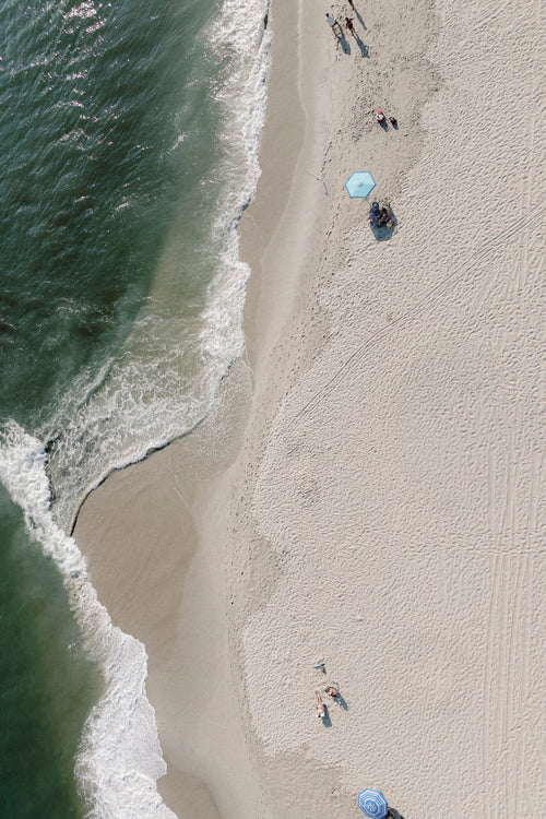 The Point aerial fine art photograph of the South Jersey shoreline with surf, beachgoers and umbrellas